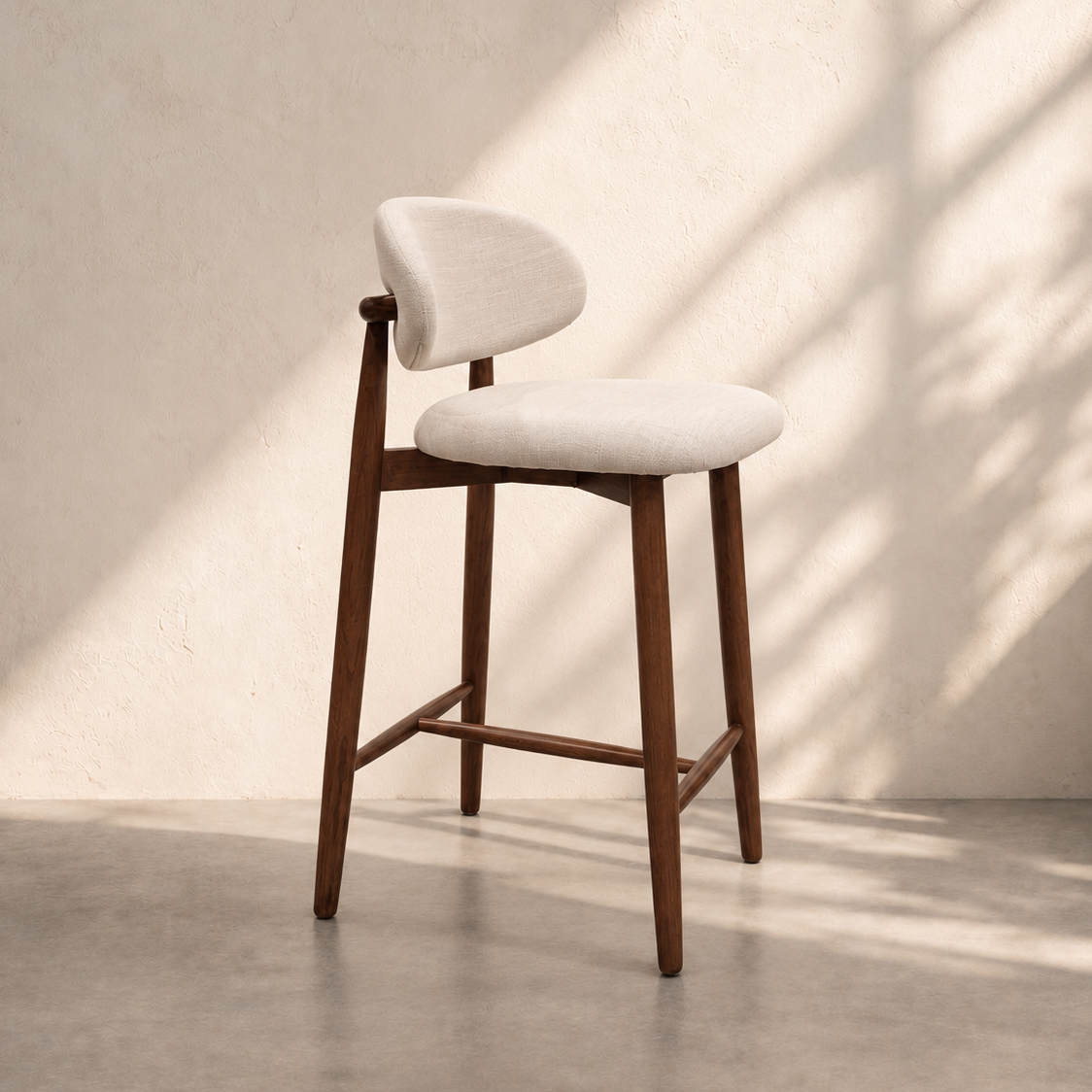 Havana Counter Stool with cream upholstered seat, curved backrest, dark brown wooden legs and footrest, ideal for modern kitchen islands in Dubai.