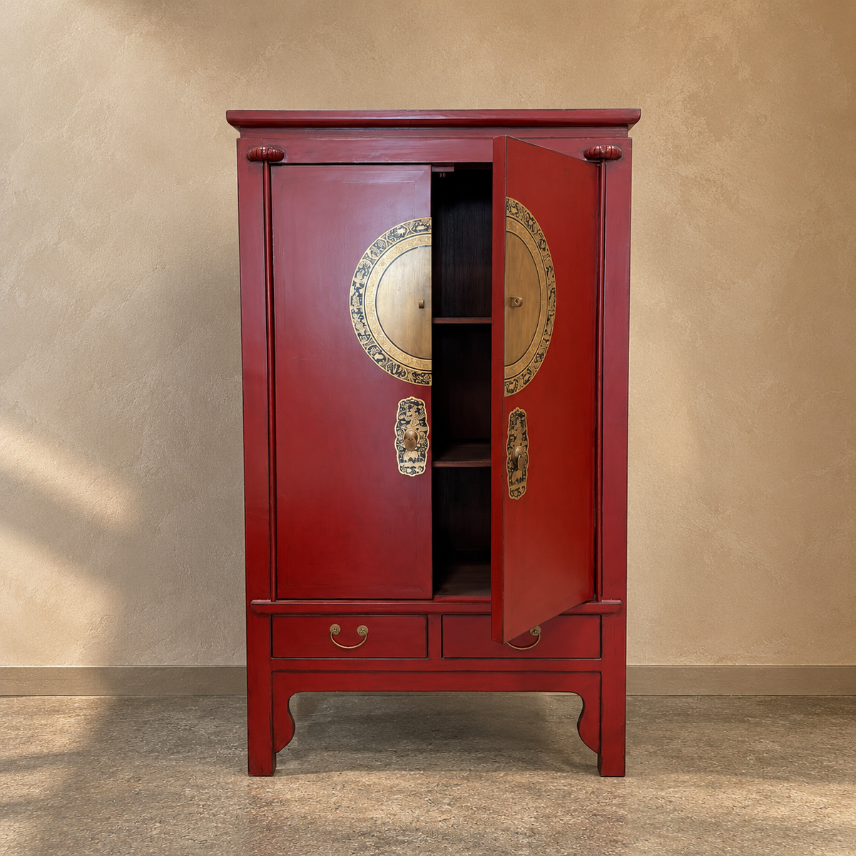 A traditional Chinese red wooden cabinet with gold accents, featuring two doors, a double drawer base, and decorative round medallions